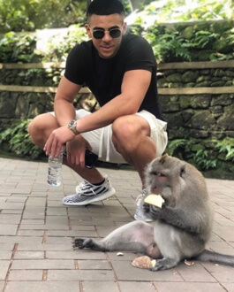 Che Adams posing with a monkey